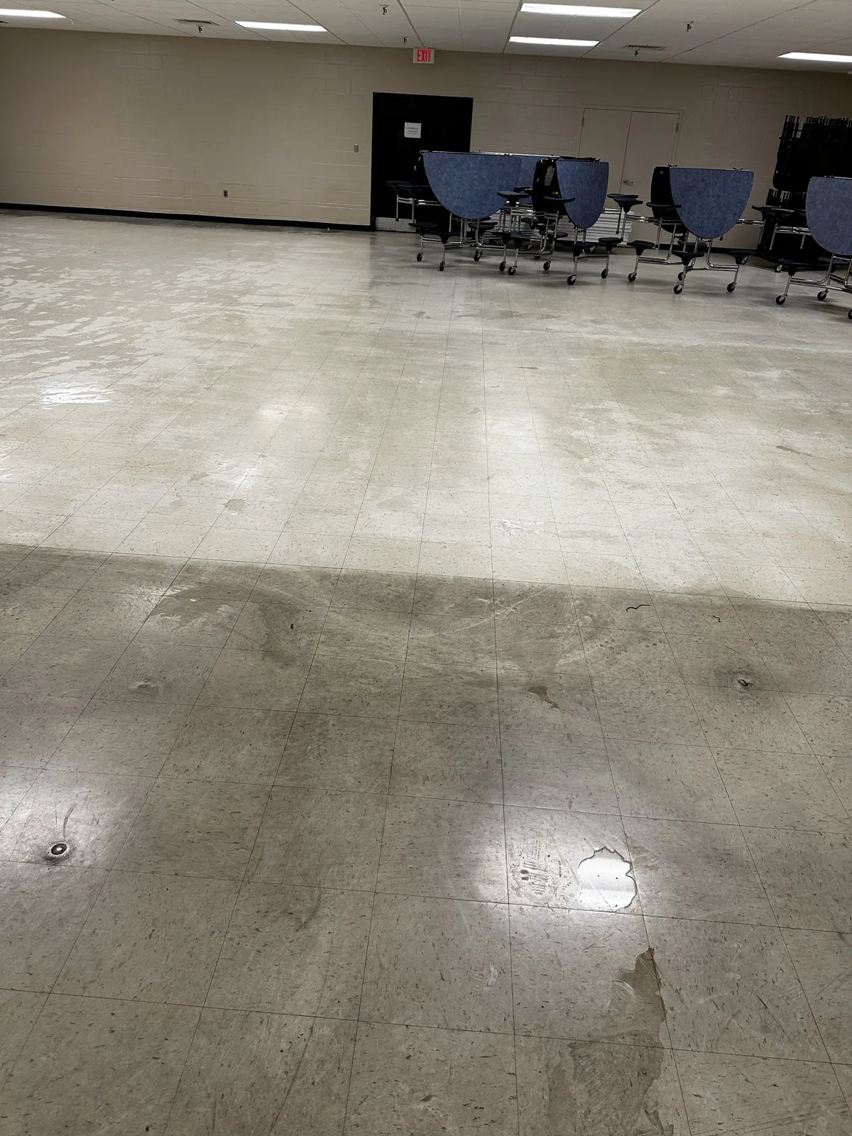 Commercial VCT floor care in progress, with folding tables moved aside.